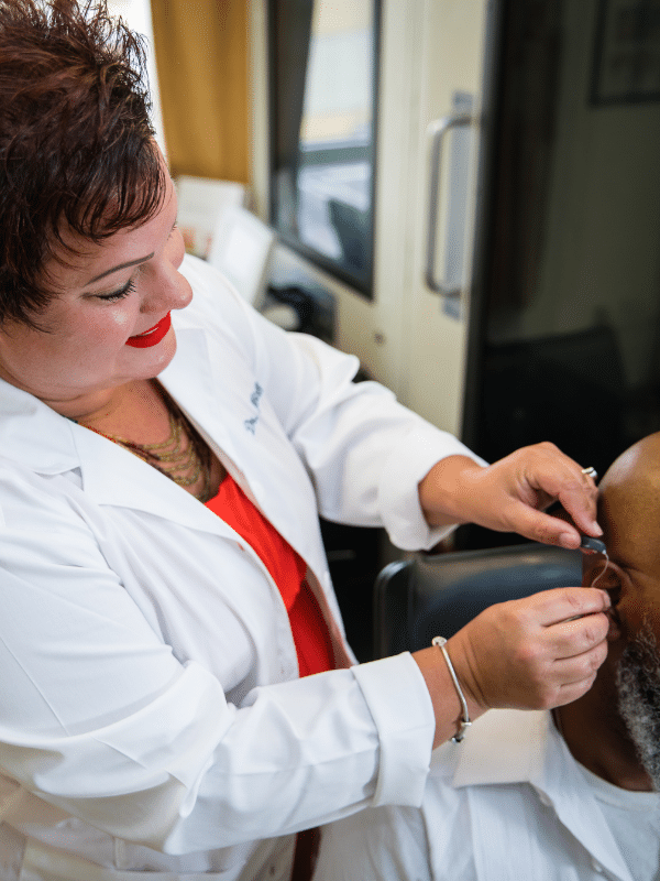 Dr Michelle fitting a hearing aid