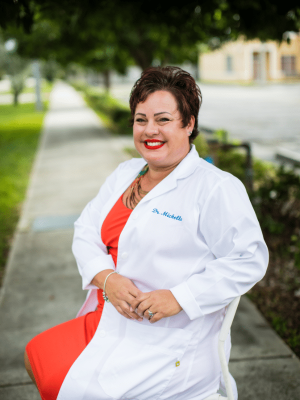 Dr. Michelle sitting on a bench outside