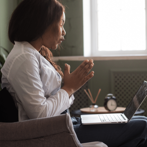 a woman having a virtual appointment on a laptop