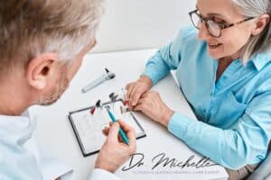 man helping woman choose a hearing aid